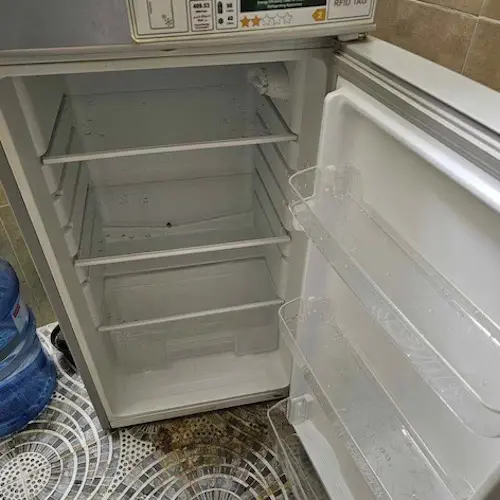 Technician testing fridge components